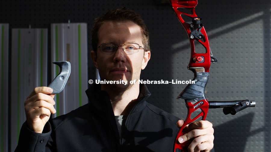 David Wolfe, a 2017 College of Business graduate, holds a 3D printed grip for his recurve bow. Wolfe is working with NIC's Maker Space to develop a custom bow grip to help him gain a spot on the Olympic Archery Team. Wolfe will train in California to try